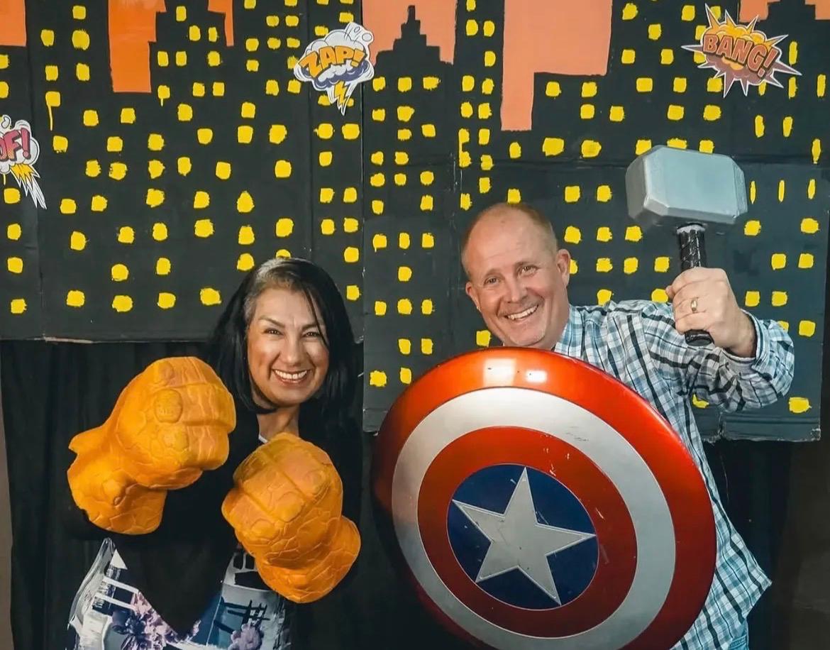David and Violeta Larson having fun at a superhero photo booth